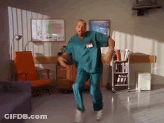 A Nurse In Scrubs Is Dancing In A Room GIF