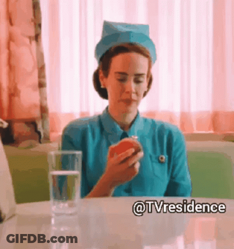 A Nurse Is Sitting At A Table With An Apple And A Glass Of Water GIF