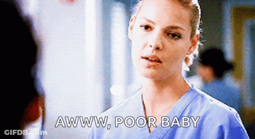 A Nurse Is Talking To A Man In A Hospital And Says Awww Poor Baby GIF