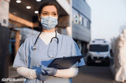 A Nurse Wearing A Mask And Gloves Holds A Clipboard GIF