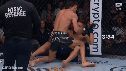 A Nysac Referee Is Watching A Fight Between Two Men GIF
