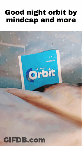 A Packet Of Orbit Gum Is Laying On A Bed GIF