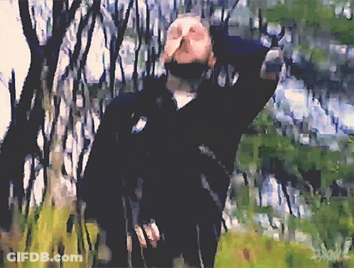 A Painting Of A Man In A Black Jacket Standing In A Forest GIF