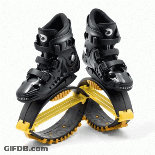A Pair Of Black And Yellow Jumping Shoes With The Letter C On The Side GIF