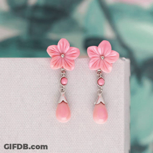 A Pair Of Earrings With Pink Flowers And Pink Drops GIF