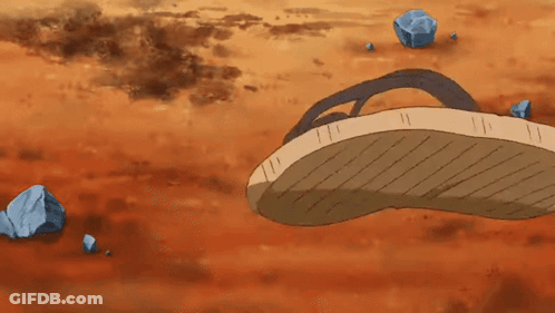 A Pair Of Flip Flops Are Laying On The Ground Next To Rocks GIF