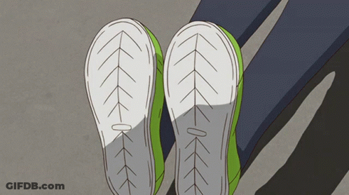 A Pair Of Green Shoes With White Soles And Arrows On Them GIF
