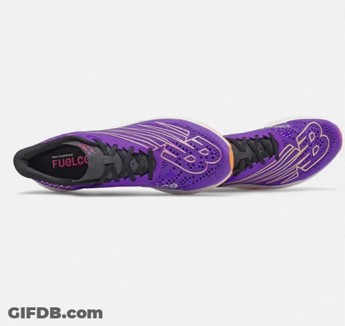 A Pair Of Purple New Balance Shoes On A White Surface GIF
