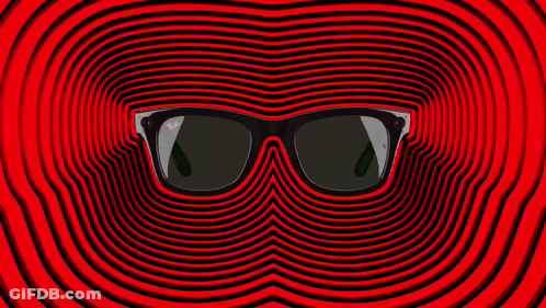 A Pair Of Ray-Ban Sunglasses Laying On A Red Surface GIF