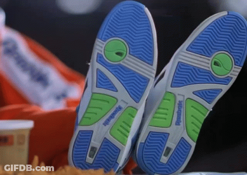 A Pair Of Reebok Shoes Are Laying On A Table GIF