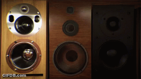 A Pair Of Speakers Sitting Next To Each Other On A Dark Background GIF