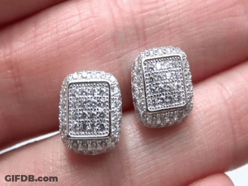 A Pair Of Square Shaped Stud Earrings Are Being Held In Someone 'S Hand GIF