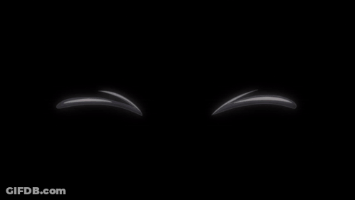A Pair Of White Balls With Red Eyes And A Black Background GIF