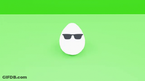 A Pair Of White Eggs With Black Spots On Them On A Green Surface GIF
