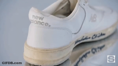 A Pair Of White New Balance Shoes With The Name Bin Clinton Written On It GIF