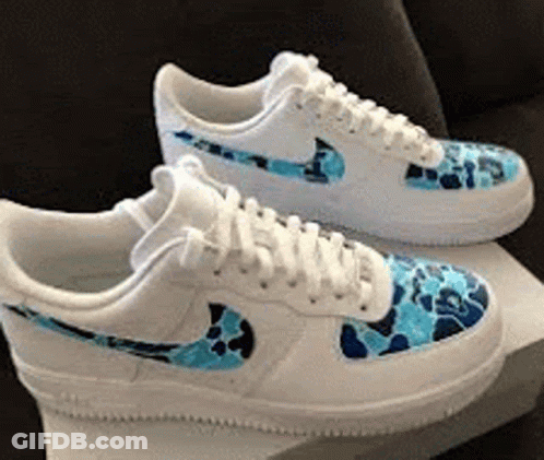 A Pair Of White Nike Air Force 1 Sneakers With A Blue Camo Pattern On Them GIF