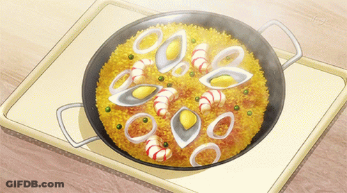 A Pan Filled With Rice And Seafood Is On A Table GIF
