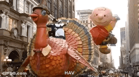 A Parade With A Turkey , Charlie Brown And A Pilgrim . GIF