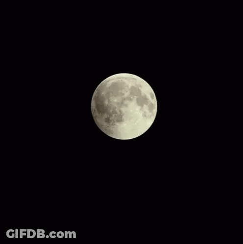 A Partial Lunar Eclipse With A Red Moon In The Dark GIF