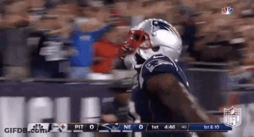 A Patriots Football Player Is Running On The Field GIF
