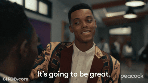 A Peacock Ad Shows A Man In A Colorful Jacket Talking To Another Man GIF