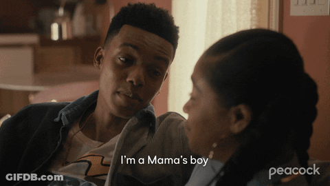 A Peacock Ad Shows A Man Talking To A Woman Who Says I 'M A Mama 'S Boy GIF