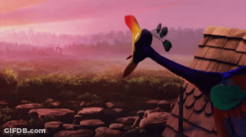 A Peacock With A Long Neck Is Standing In Front Of A Roof GIF