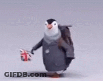 A Penguin Carrying A Backpack And Holding A British Flag GIF