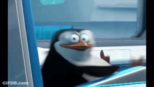 A Penguin From Madagascar Is Sitting In A Chair And Making A Funny Face GIF