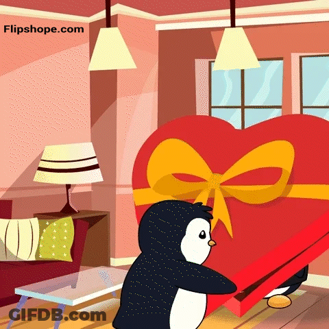 A Penguin Is Holding A Heart Shaped Box In A Living Room GIF