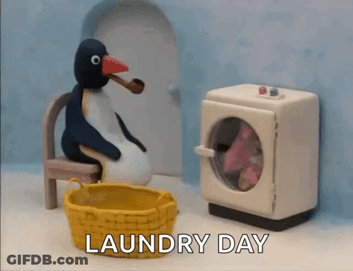 A Penguin Is Sitting In A Chair Next To A Washing Machine With The Words Laundry Day Written On The Bottom GIF