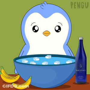 A Penguin Is Sitting Next To A Bowl Of Ice And Bananas GIF
