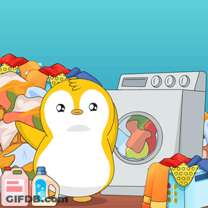 A Penguin Is Standing In Front Of A Washing Machine With Clothes In It GIF