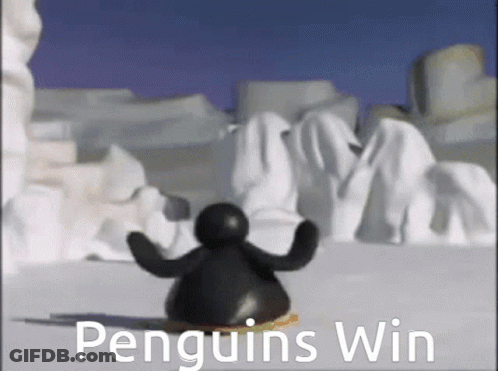 A Penguin Is Standing In The Snow With The Words Penguins Win Behind Him GIF
