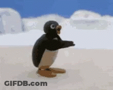 A Penguin Is Standing On Its Hind Legs On A Snowy Beach . GIF