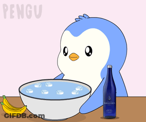 A Penguin Is Taking A Bath In A Bowl Of Water GIF