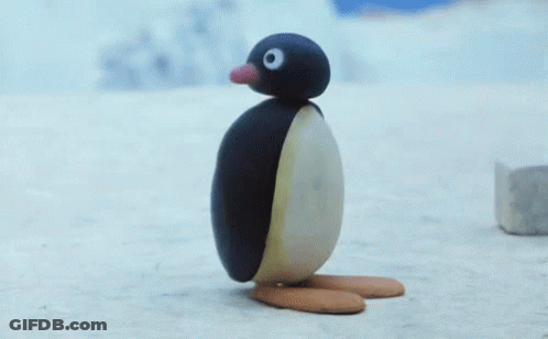 A Penguin Made Out Of A Piece Of Ice Is Standing On The Snow . GIF