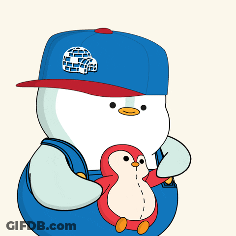 A Penguin Wearing A Blue Hat And Overalls Is Holding A Stuffed Animal GIF