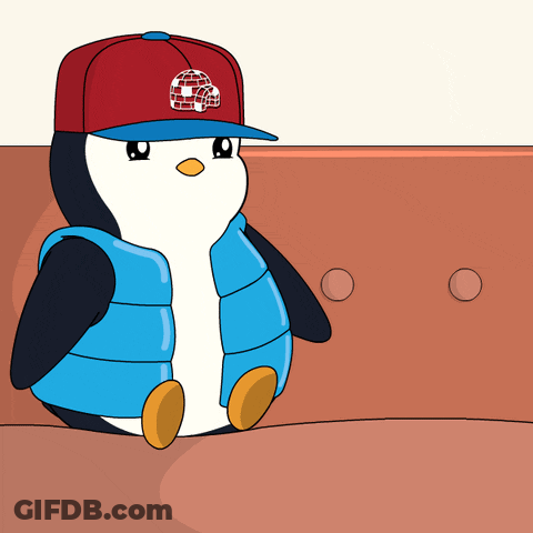 A Penguin Wearing A Blue Jacket And A Red Hat Is Laying Down GIF