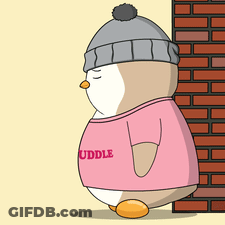 A Penguin Wearing A Pink Shirt That Says " Cuddle " Is Standing In Front Of A Brick Wall GIF