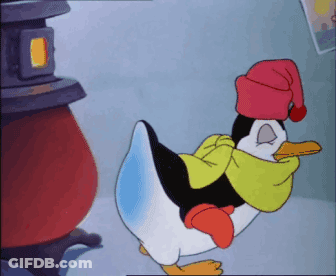 A Penguin Wearing A Red Hat And Scarf GIF