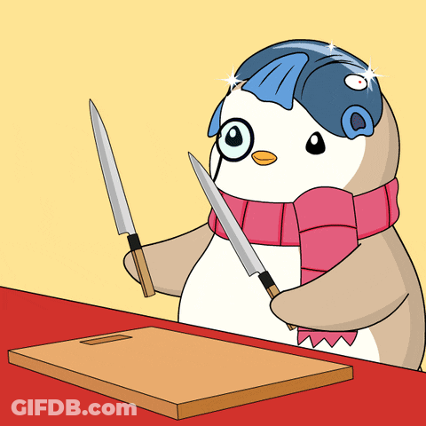 A Penguin Wearing Glasses And A Scarf Holds Two Knives In Front Of A Cutting Board GIF