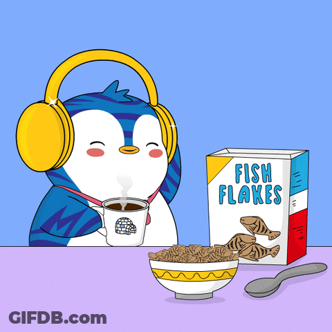 A Penguin Wearing Headphones Sits At A Table With A Bowl Of Fish Flakes And A Box Of Fish Flakes GIF