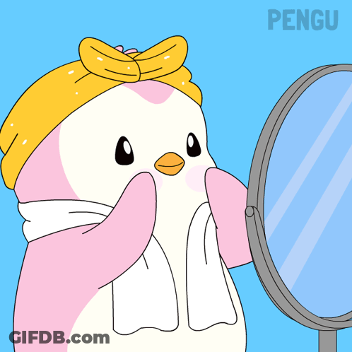 A Penguin With A Towel Around Its Neck Looks In A Mirror GIF