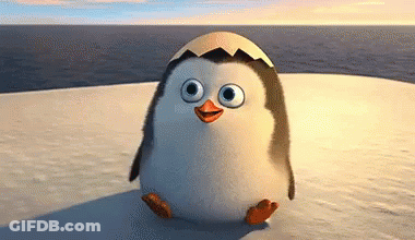 A Penguin With An Egg On Its Head Is Standing On A Snow Covered Island . GIF