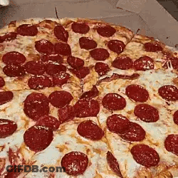 A Pepperoni Pizza Is Sitting In A Cardboard Box With A Slice Missing . GIF