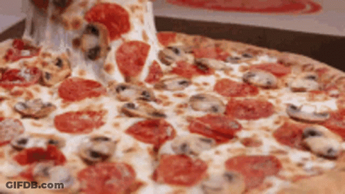 A Pepperoni Pizza With Mushrooms And Cheese Being Taken Out Of A Box GIF