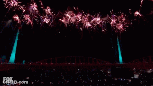 A Pepsi Halftime Show With Fireworks Going Off Behind It GIF