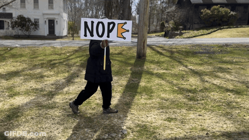 A Person Carrying A Sign That Says Nope GIF