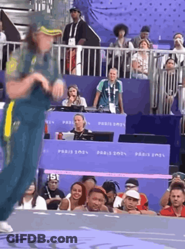 A Person Dancing In Front Of A Sign That Says Paris 202 GIF